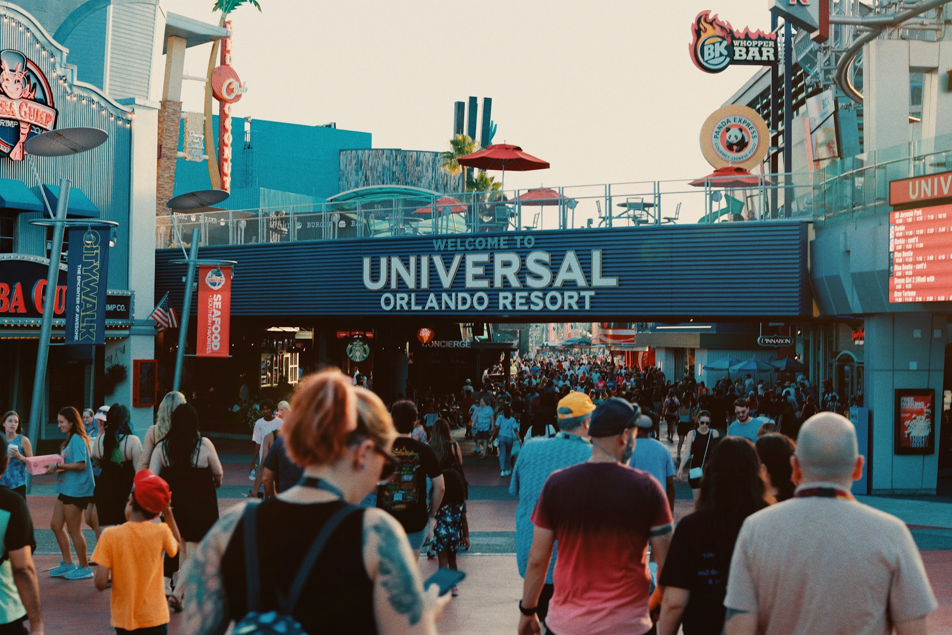 A family group walking through a busy theme park